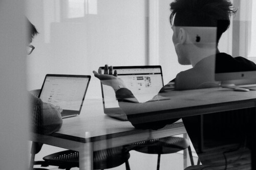 two-men-working-on-computers-in-a-conference-room.jpg