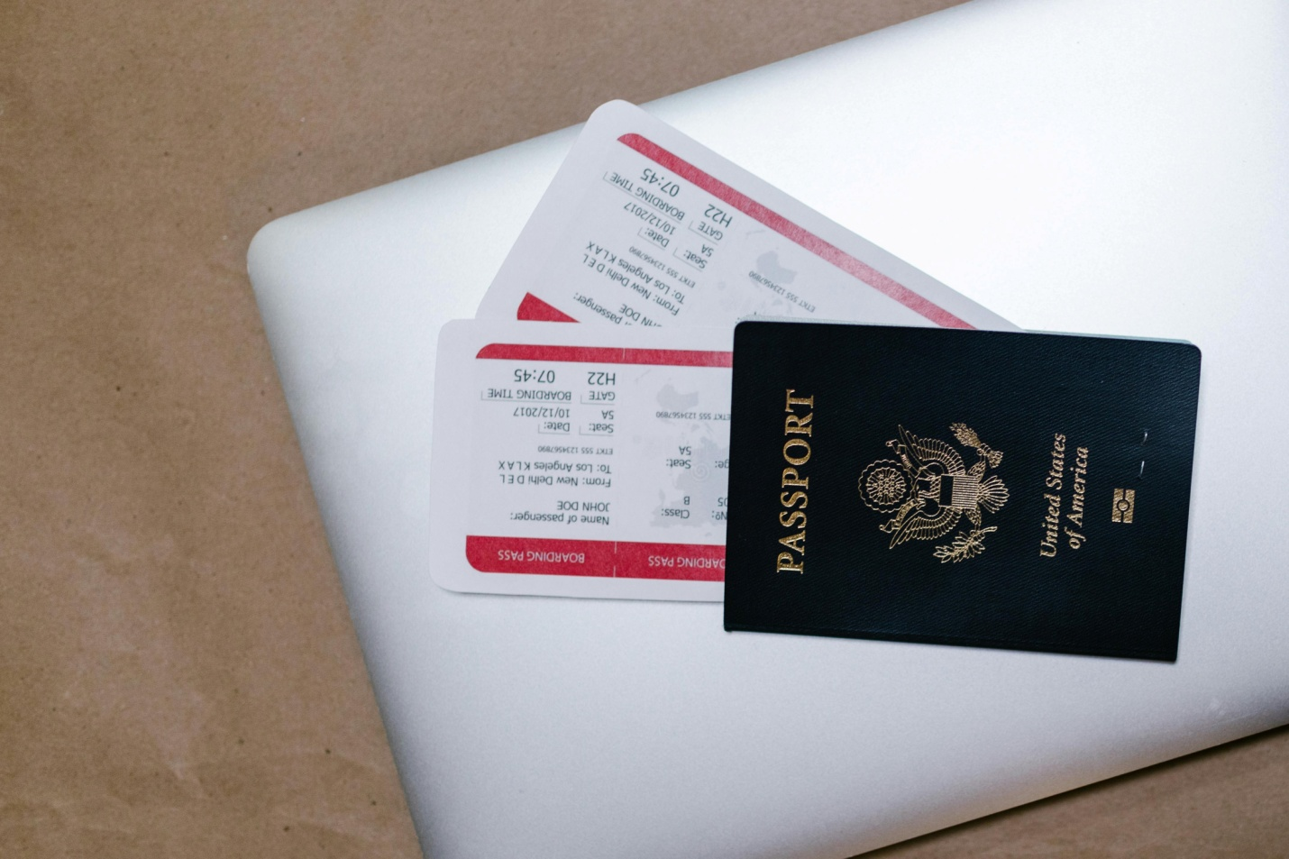 A US Passport and Two Tickets on a Laptop