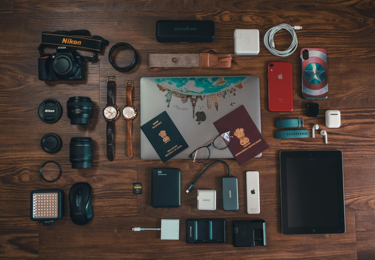 Two Passports, Watches, Camera, Camera Accessories, Cellphone Covers, Powerbank, and Other Travel Essentials