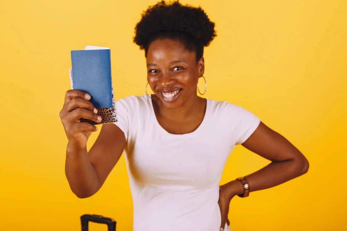 A happy woman showing off her passport 